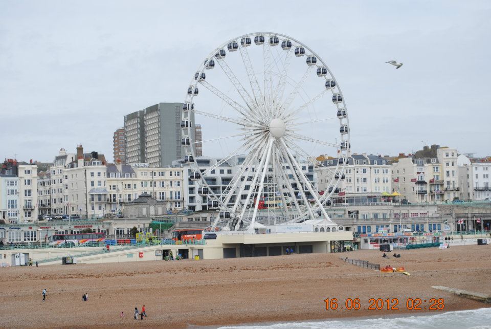 brighton beach wheel and city viewed from pier during a weekend in brighton