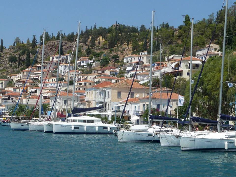 poros shore with boats and buildings from a yacht