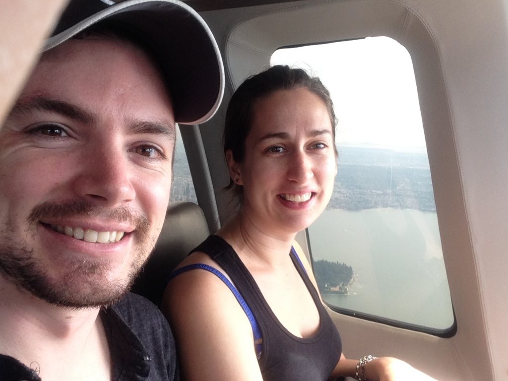 Young man and young woman in helicopter over Vancouver Canada