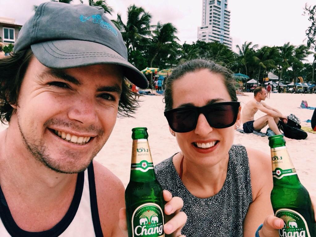 Couple drinking beer on beach when visit Patong Beach Phuket