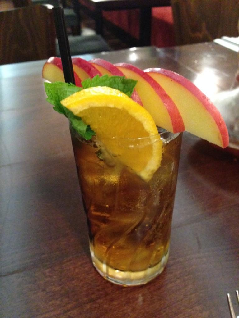 Pimms Cup with fruit and a black straw