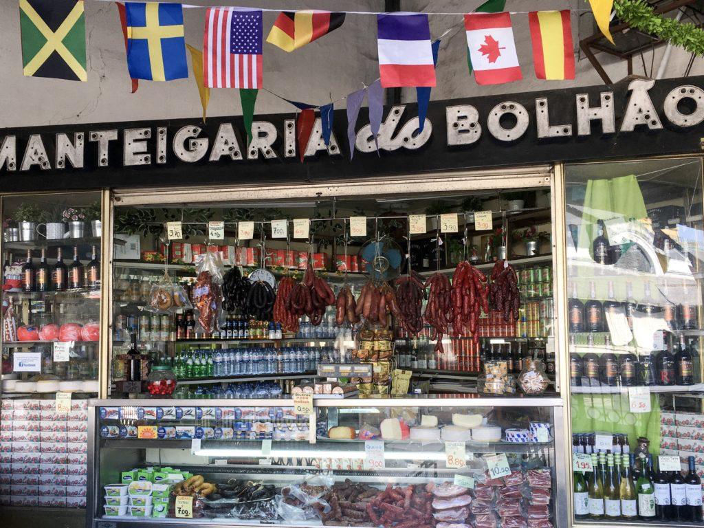 upstairs market in Porto with cured meats, wine and bunting