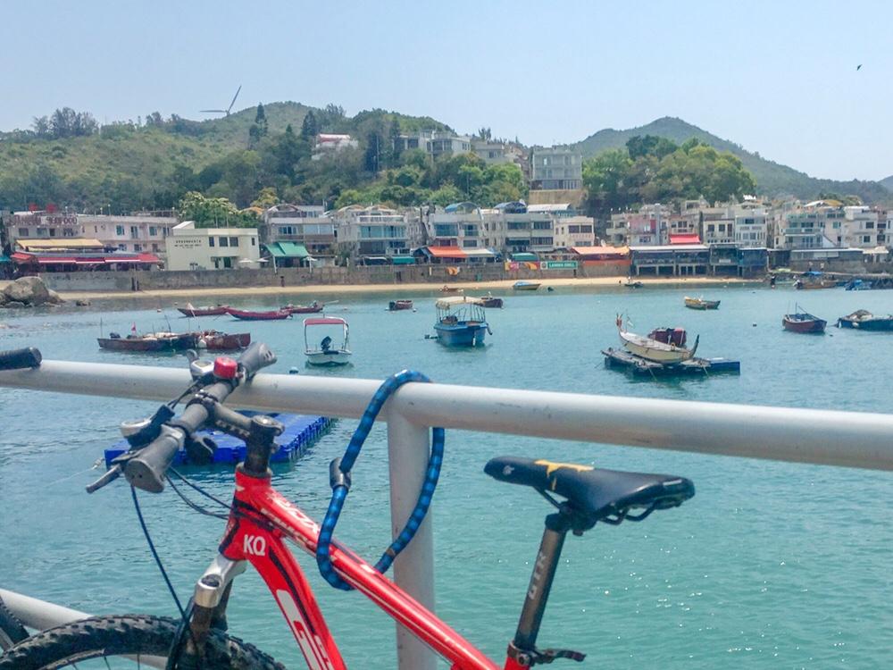 view of bike and lamma island fishing boats from ferry terminal