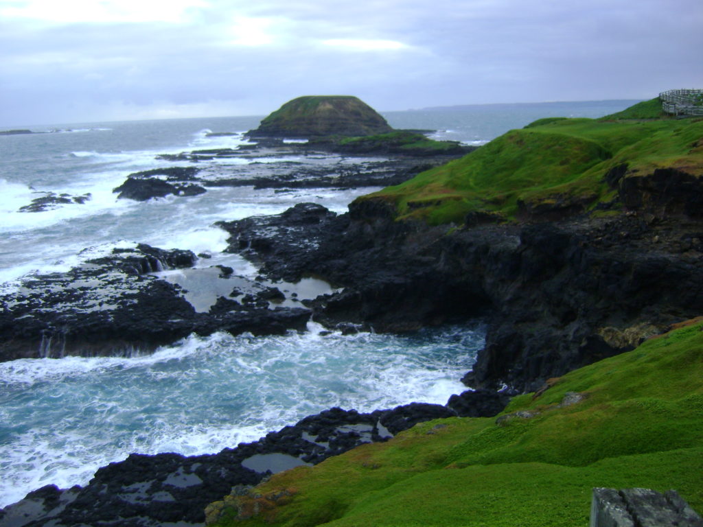 rocky coast with green cliffs