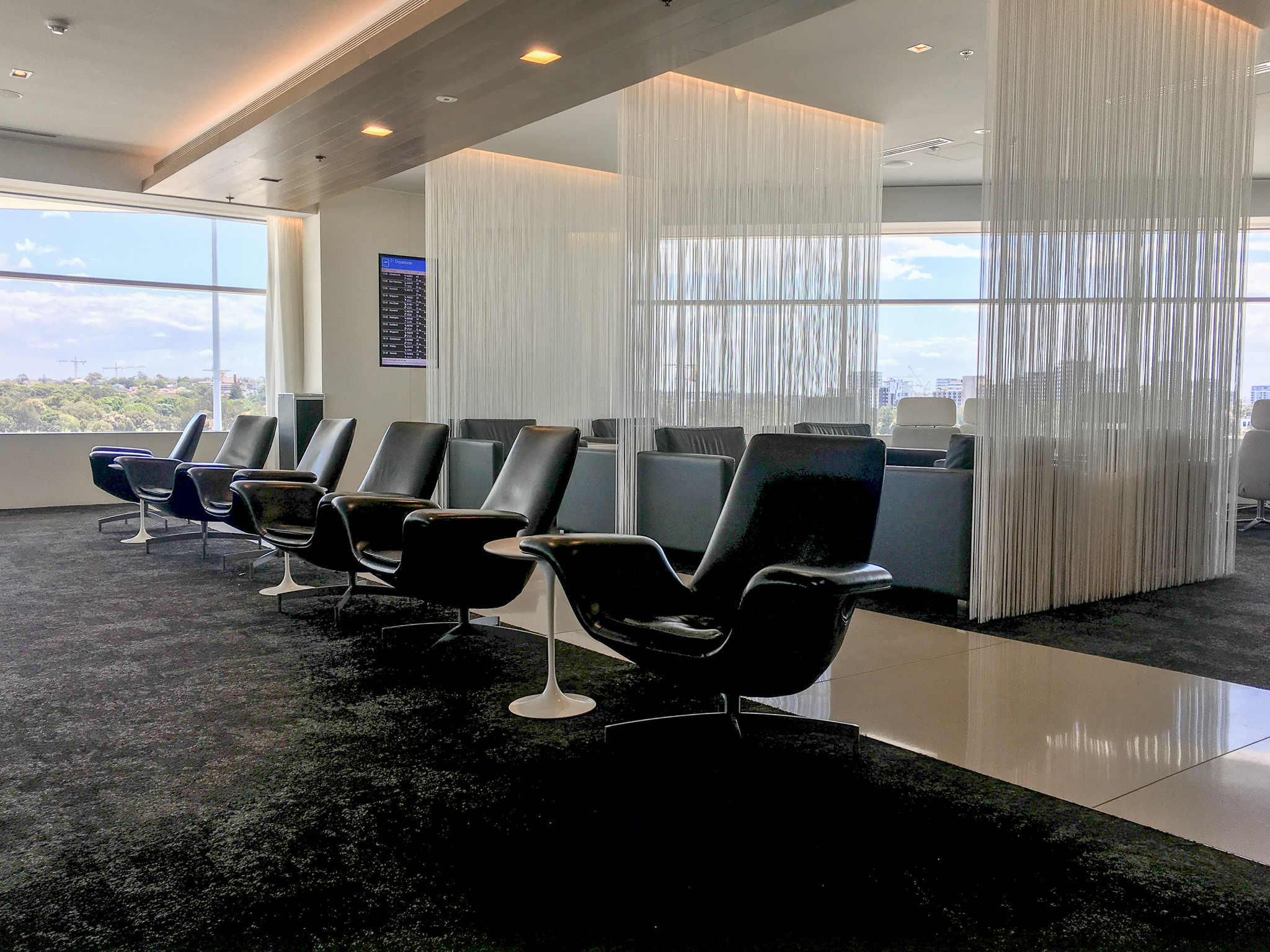 Black swivel chairs in Koru Lounge Sydney Airport