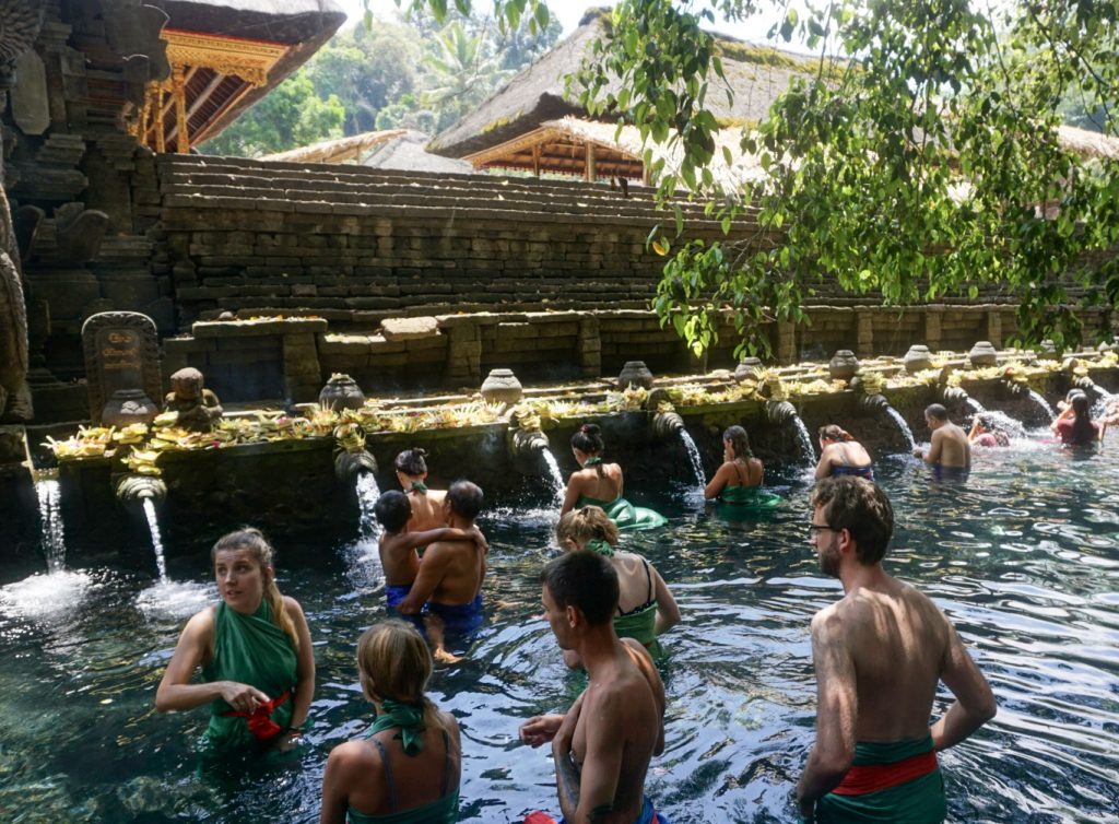 tourists in water at temple in ubud bali