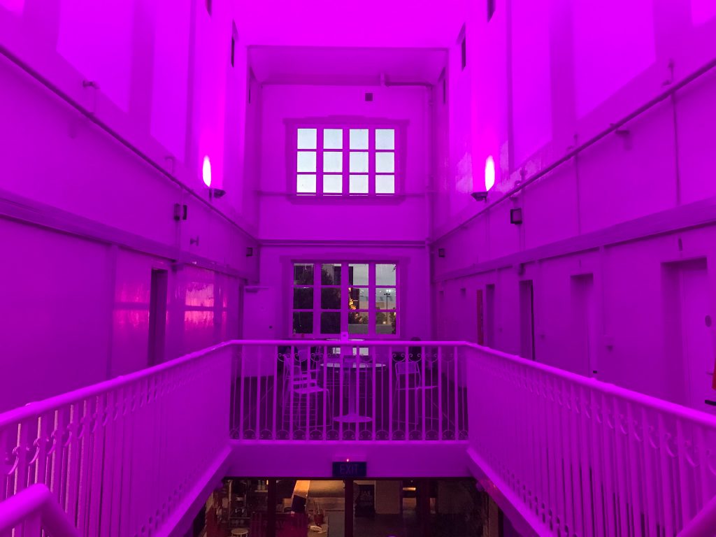Inside Jailhouse Accommodation lit up pink at night