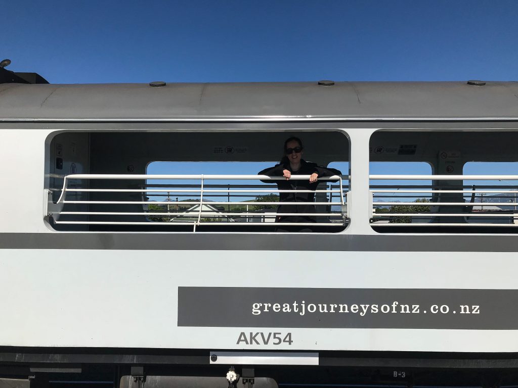 Young woman inside Coastal Pacific Train open carriage