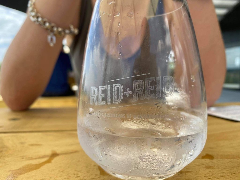 reid + reid branded glass containing gin and tonic