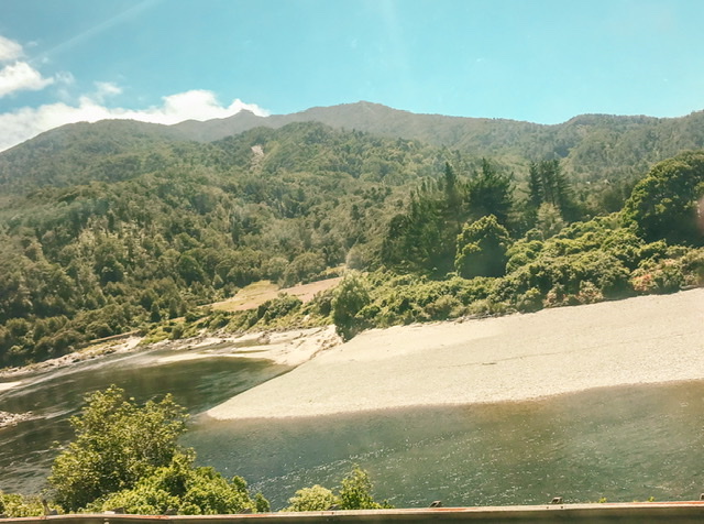 South Island river bed with mountainous bush in background