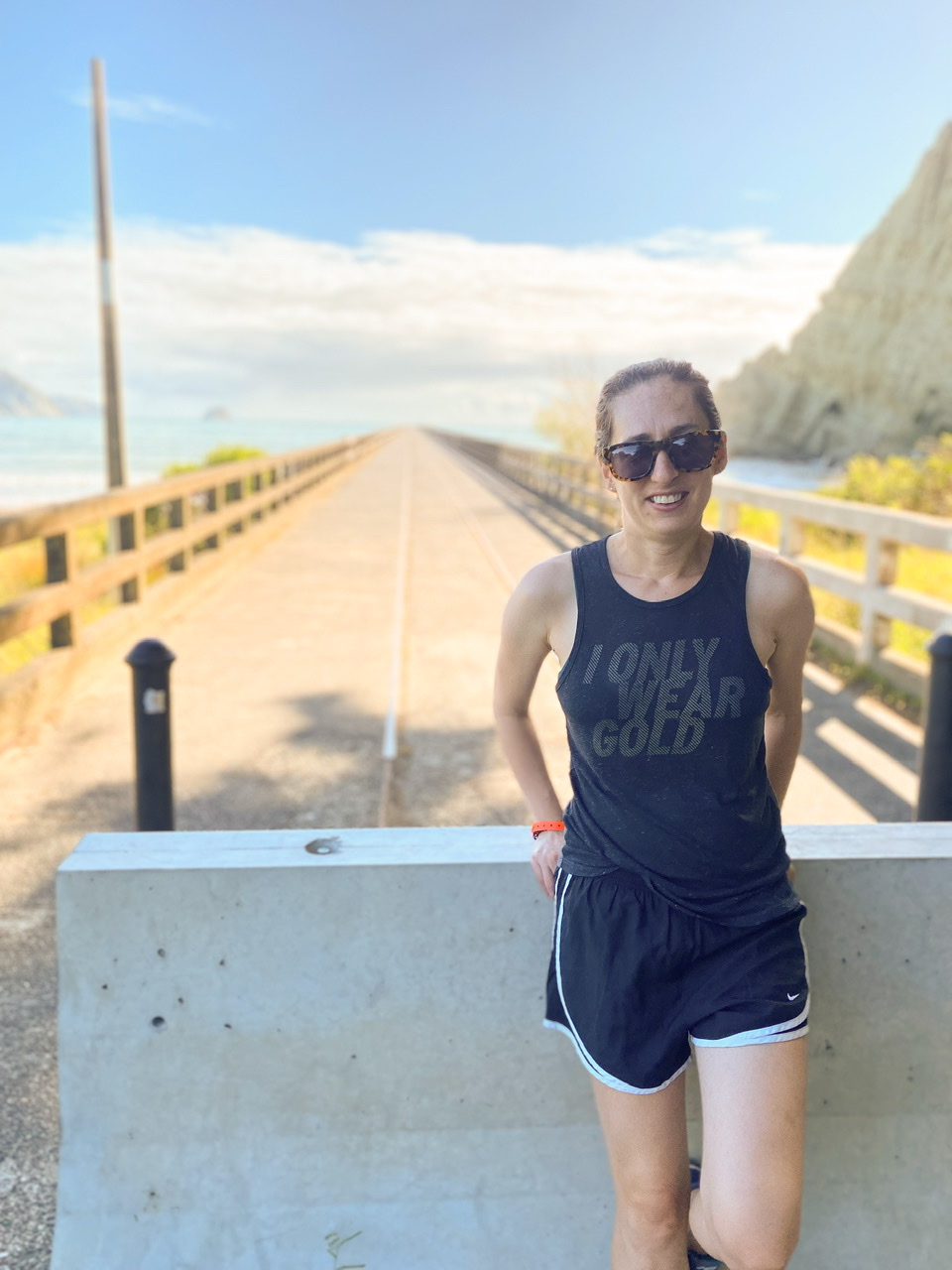 Young woman standing at end of Tolaga Bay Wharf