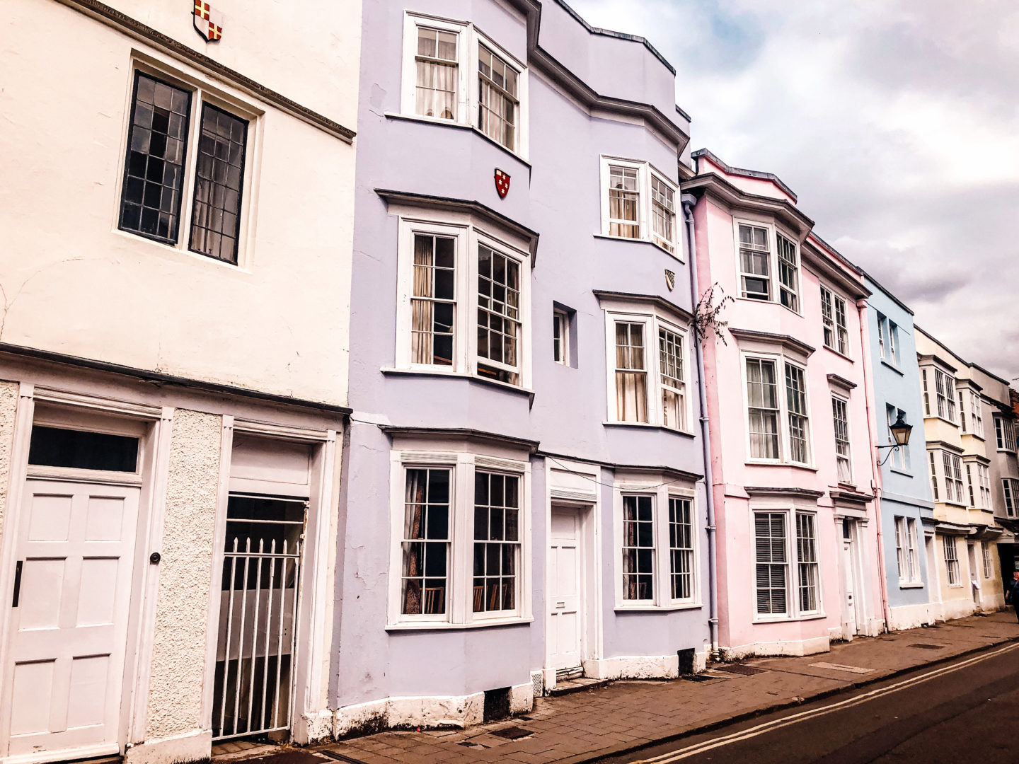 Line of colourful houses - beige, lavender, pink, blue, light yellow,on Holywell Street in Oxford