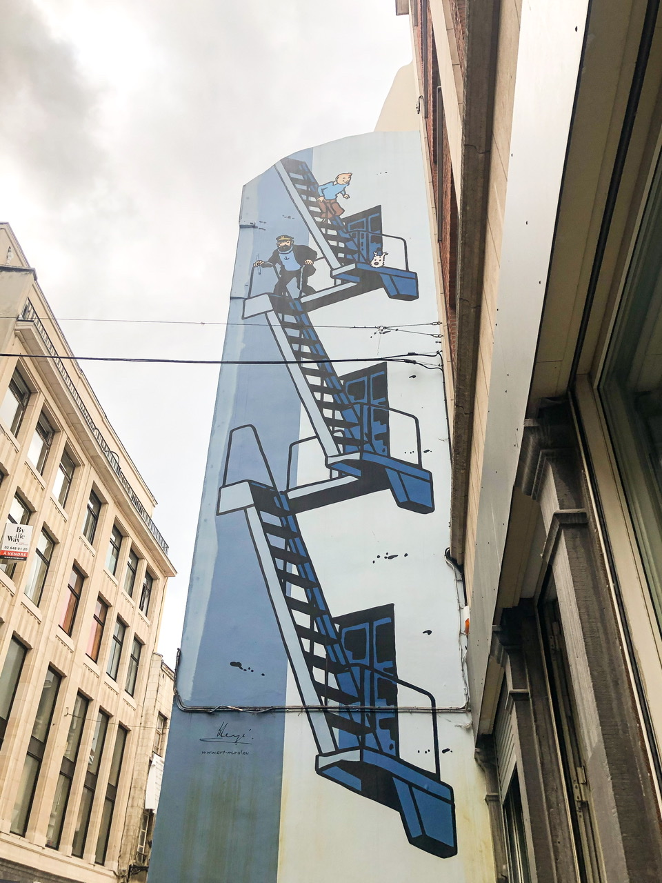 Wall in Brussels painted with and three characters from Asterix comics on stairs