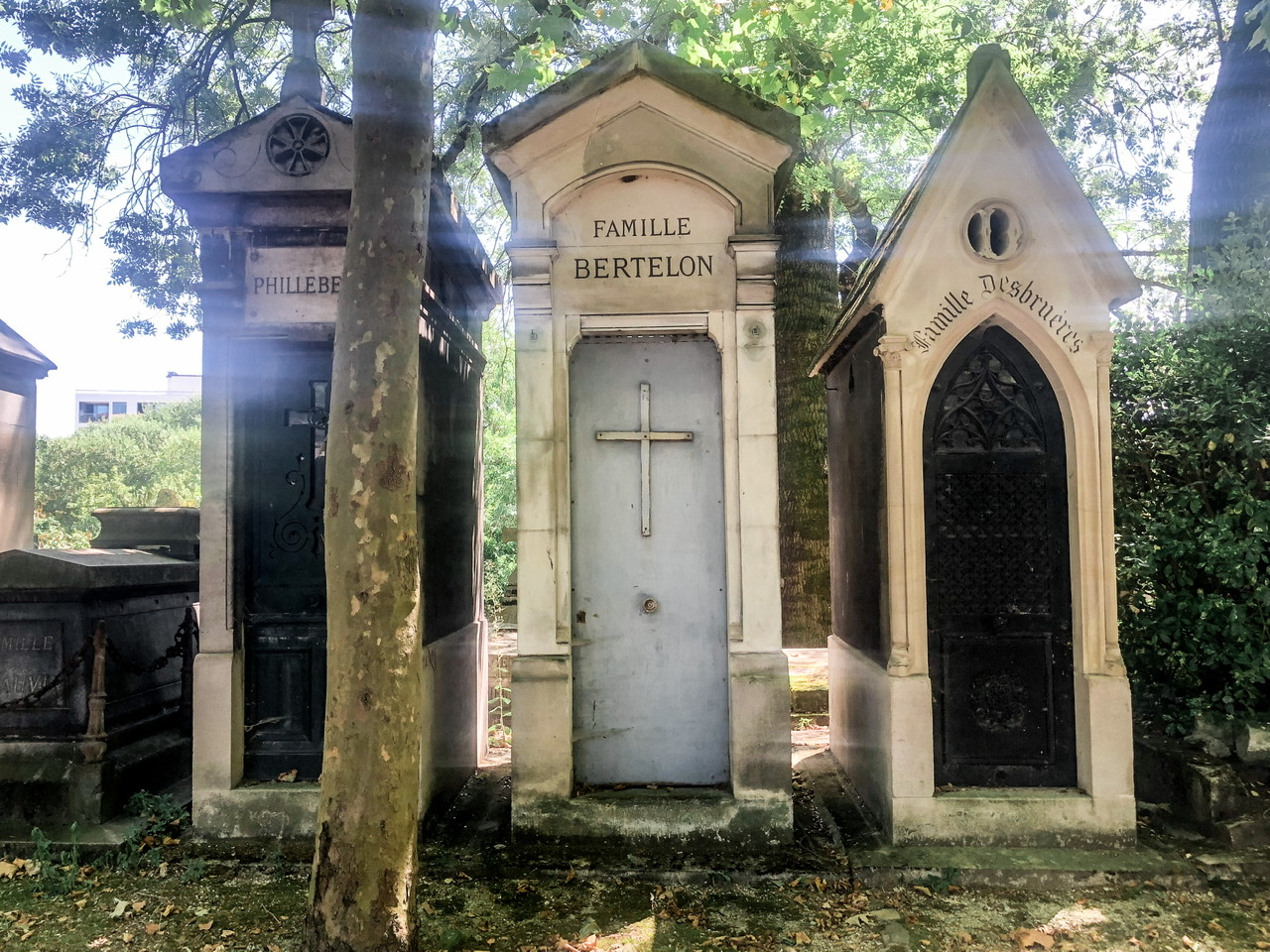 Three tall, skinny family vaults in Graves in Parc Père Lachaise Cemetery Paris