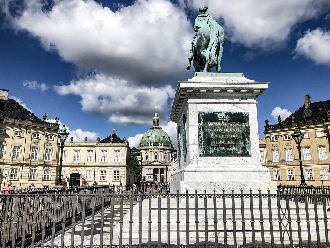 statue of person on horse in Amalienbourg courtyard with royal residences and marble church visible in background