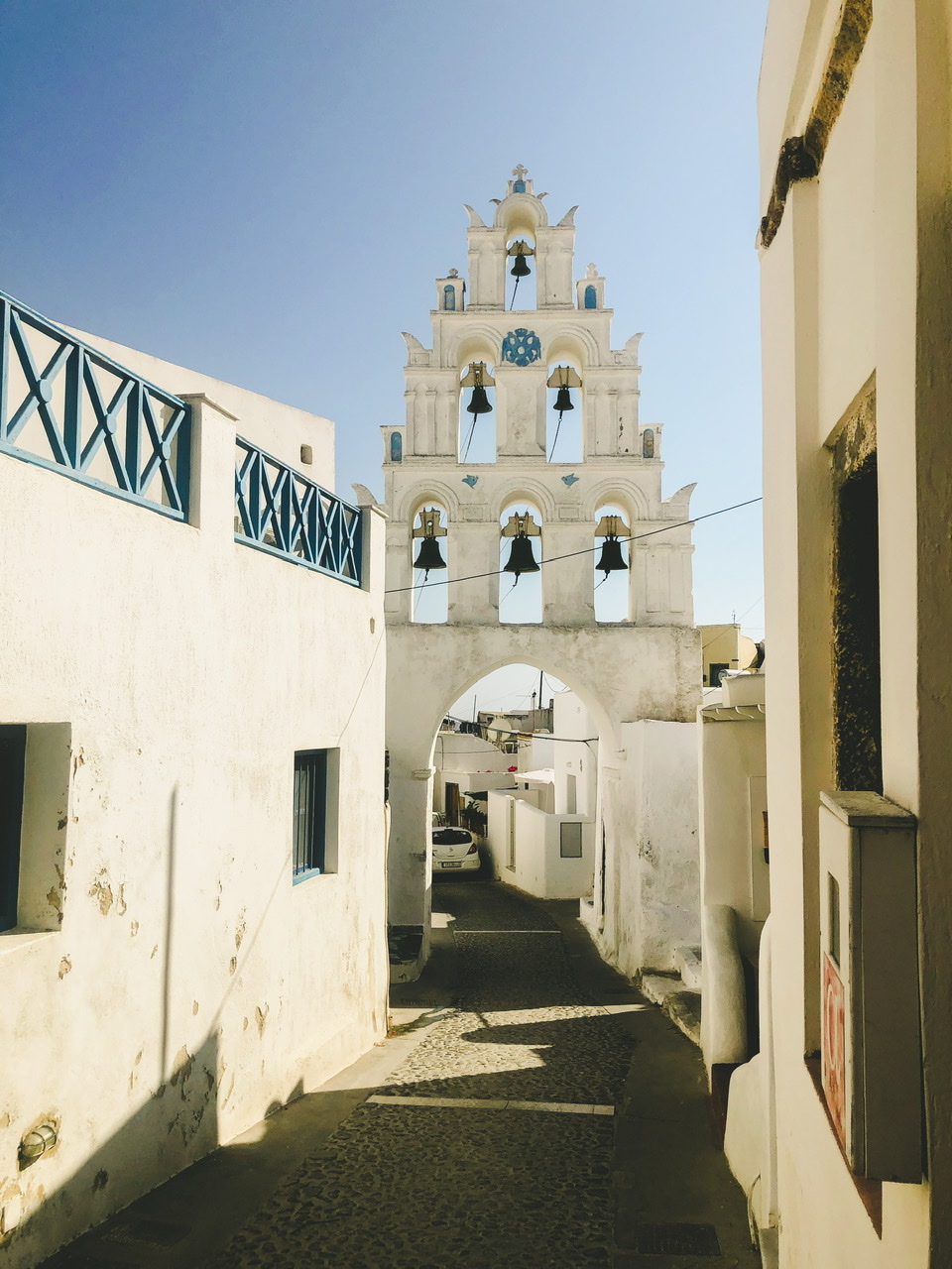 White and blue five bell tower in Megalochori Santorini