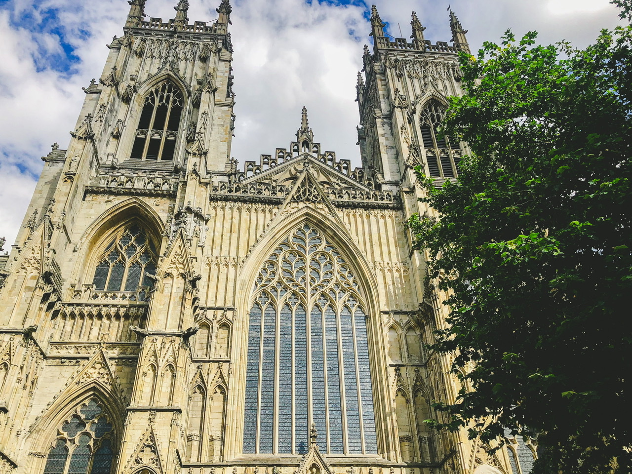 Medieval York Cathedral with two main spires either side of centre building with large glass window