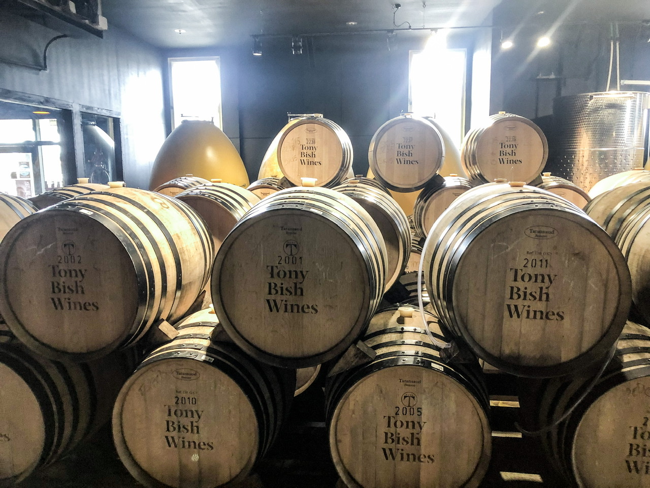 Interior of barrel room at Tony Bish Wines, stacked two high and four rows deep