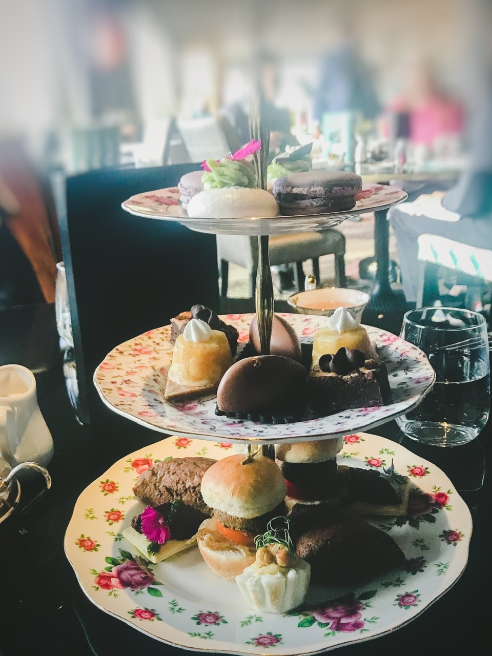 Three tiered high tea stand on table decorated with black table clothat Hippopotamus Wellington
