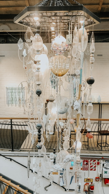 A Glass Chandelier hanging from the ceiling at New Zealand Glassworks in Whangaui. Each piece of hanging glass has been created by a different glass artist so they are all unique.