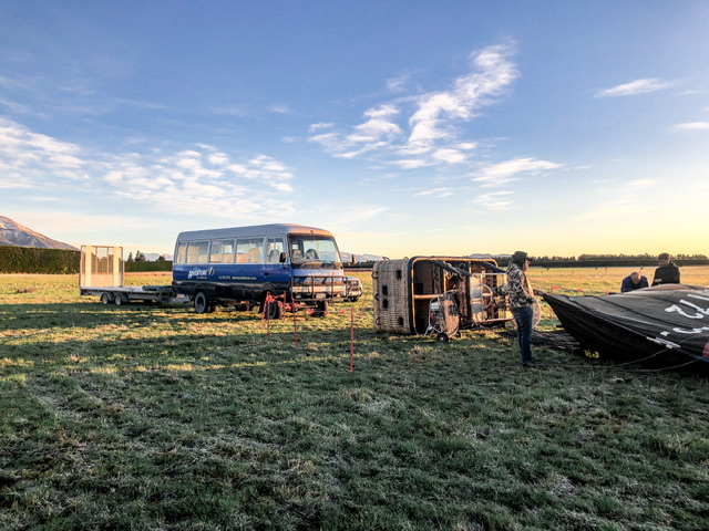Adventure Balloons vehicle and balloon being set up in a frosty paddock with mountains in the background.