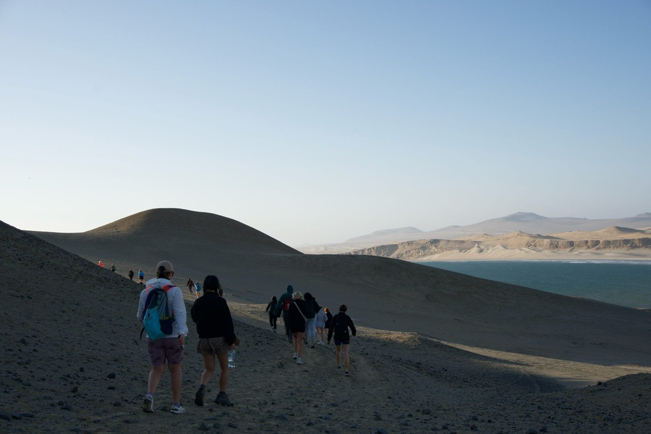 A tour group walk around the Paracas National Reserve on a Golden Shadows Trek