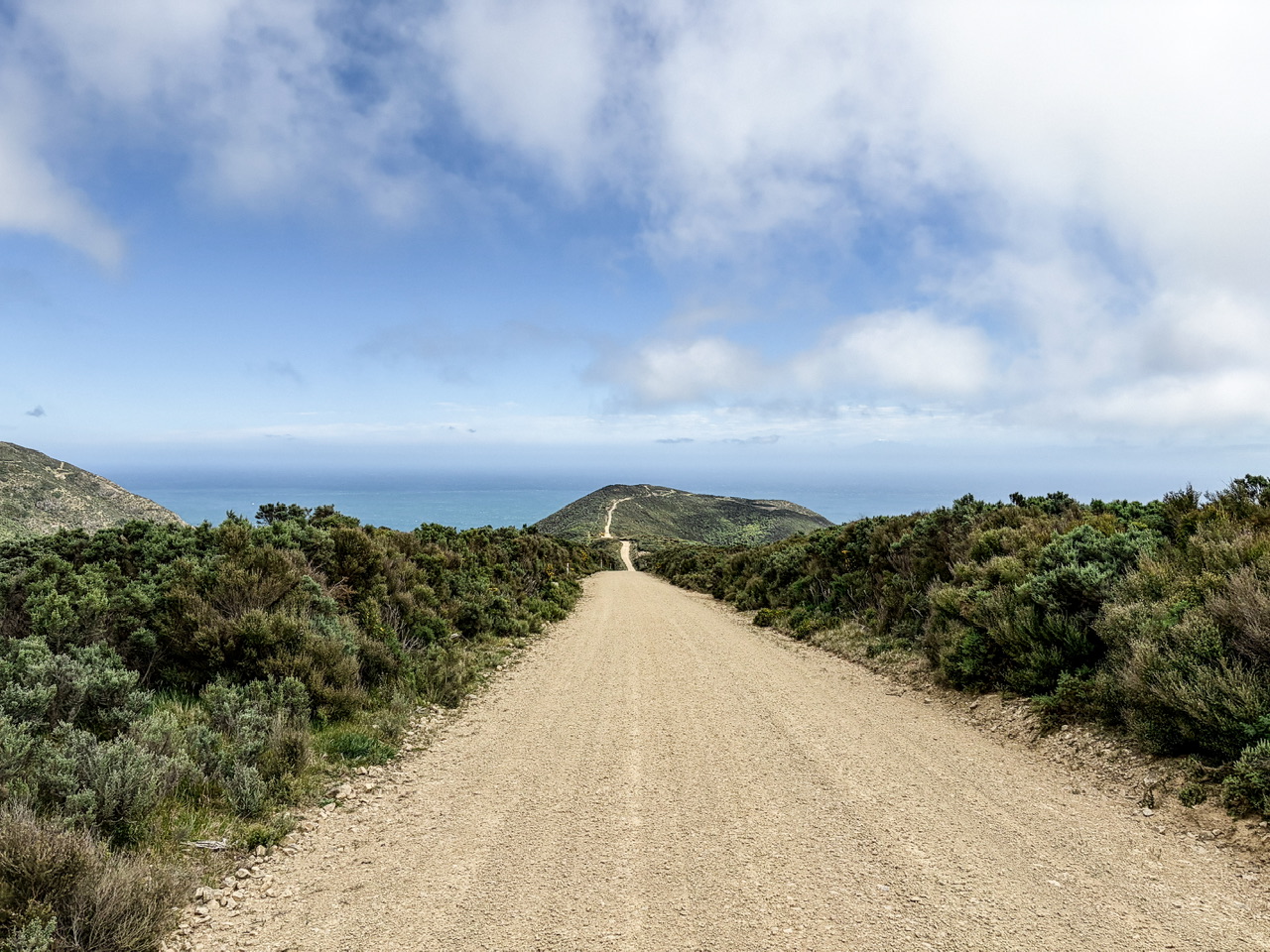 Windy unsealed road out to The Ocean House through Kinnock Station.