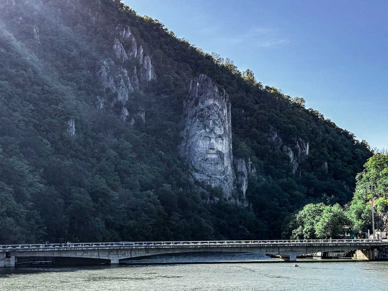 Decebalus Rex 55m tall face carved in cliff seen from the Danube River